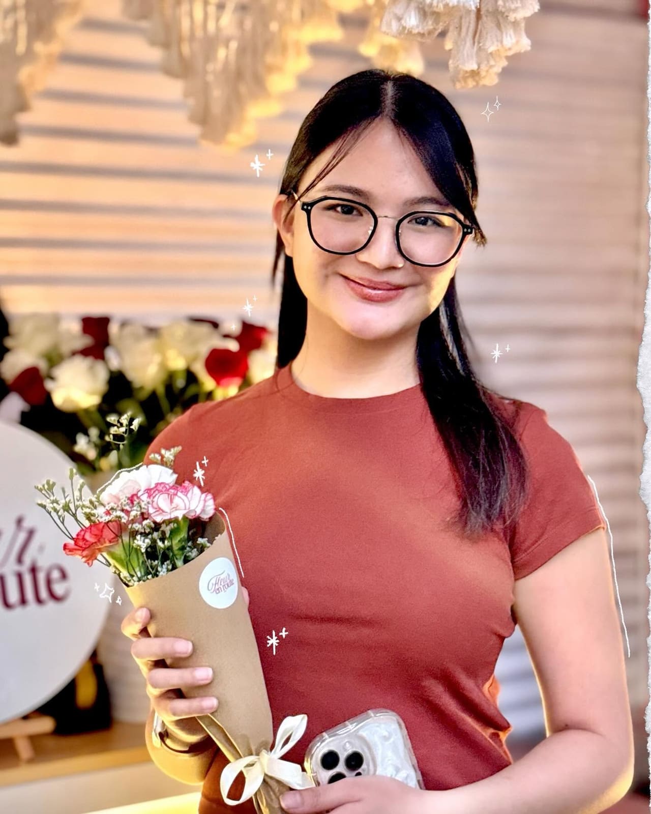 A customer smiling with a small kraft cone bouquet at a café pop-up