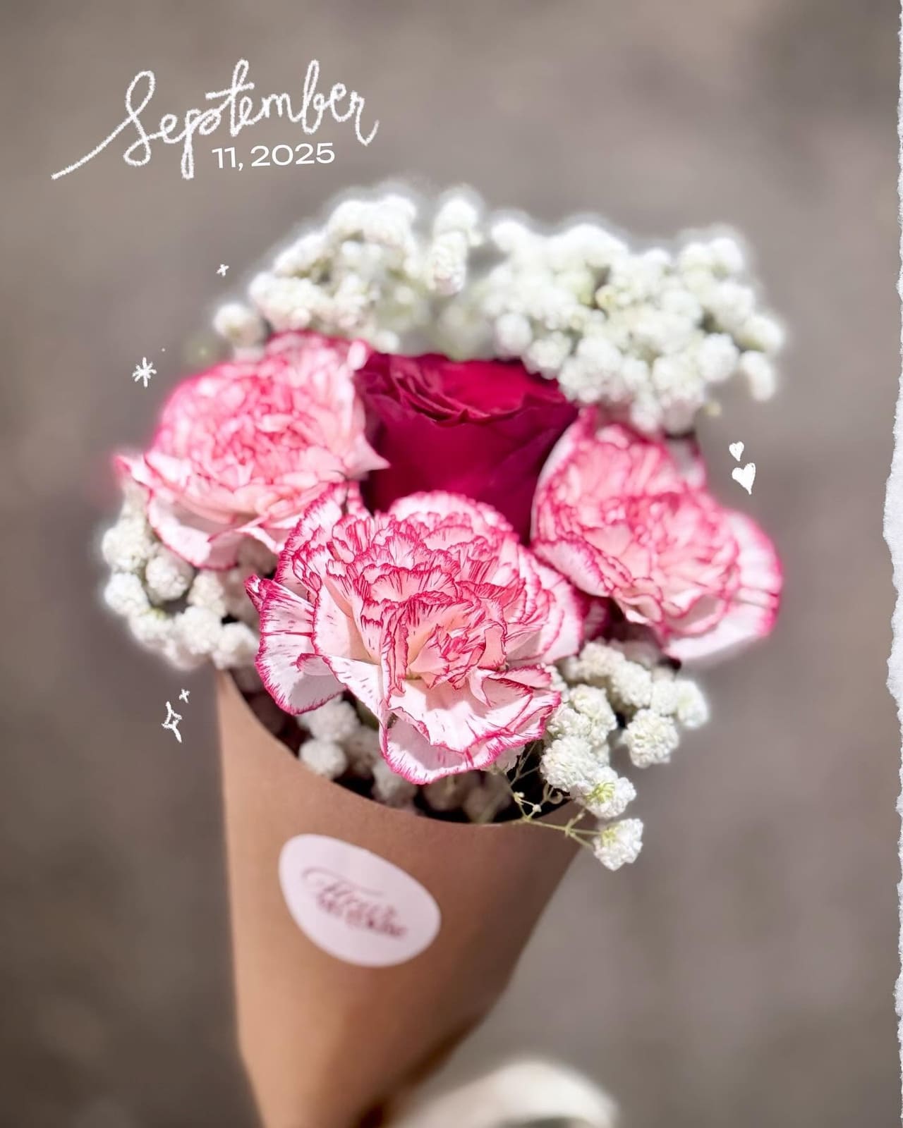 Kraft cone of two-toned carnations and baby's breath, dated September 11, 2025